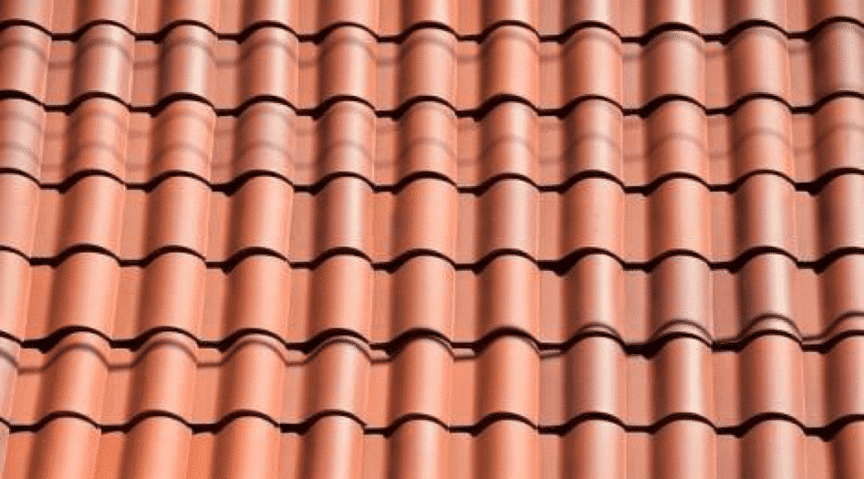 A roofer and a customer talking outside of a house.